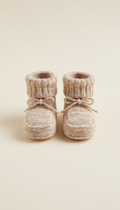 Knit booties in whisper pink